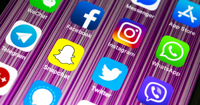 social media screen on phone: State Department Now Requires Visa Applicants Share Their Social Media Accounts | Godoy Law Office