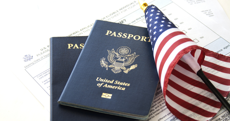 Passport and American Flag: How Long After I Get My Green Card Can I Become a Citizen? | Immigration Lawyer Mario Godoy | Godoy Law Office