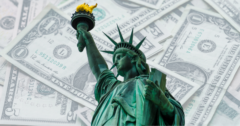 Statue of Liberty with dollar bill background: Wealth Test for Green Cards | Immigration Lawyer Mario Godoy | Godoy Law Office